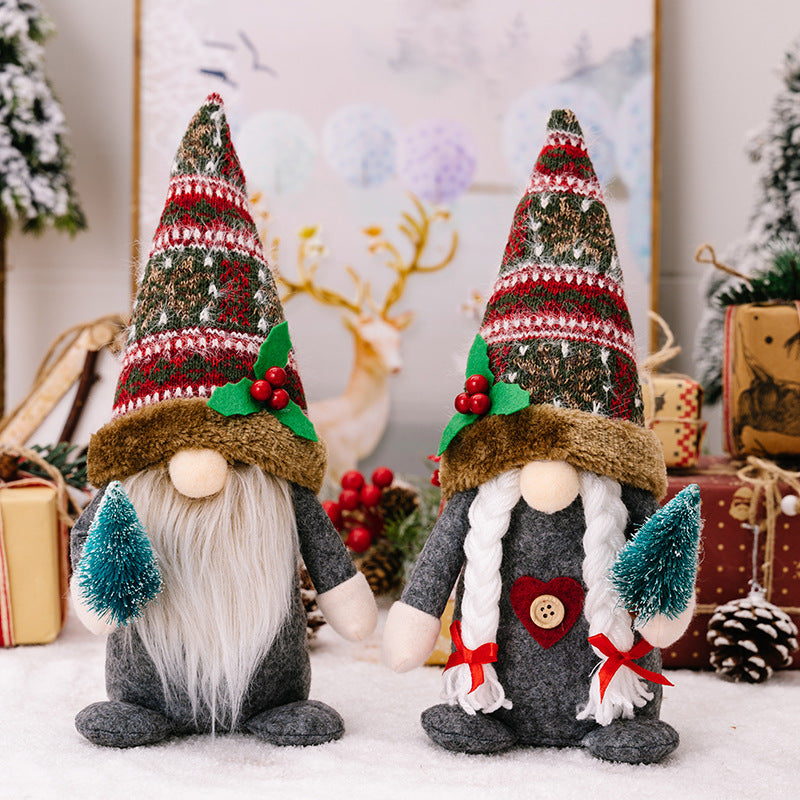 Creative forest gnomes holding Christmas tree