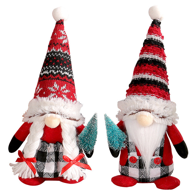 Red Christmas gnomes holding small tree