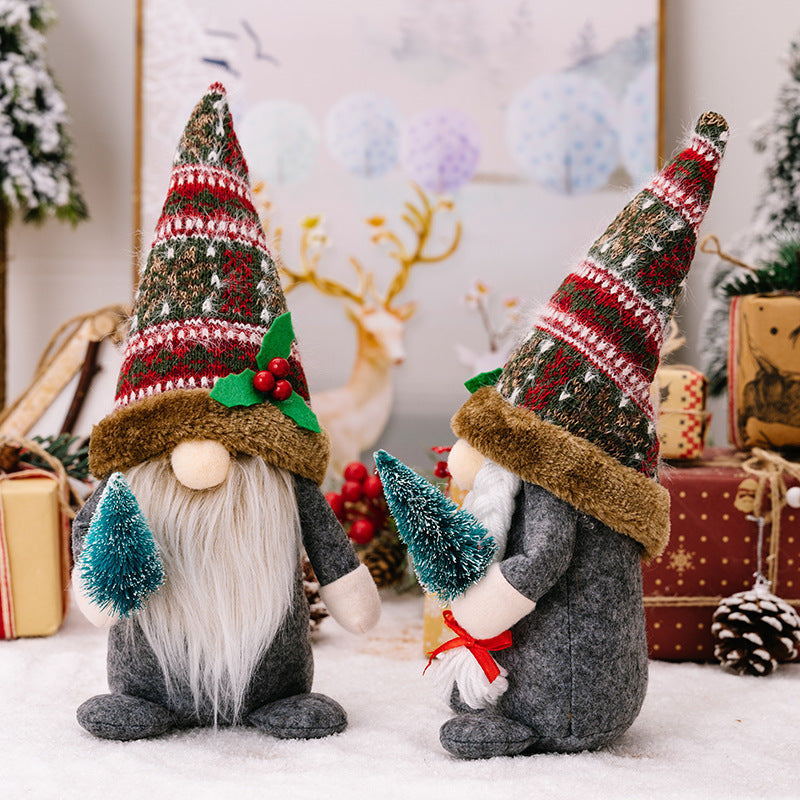 Creative forest gnomes holding Christmas tree